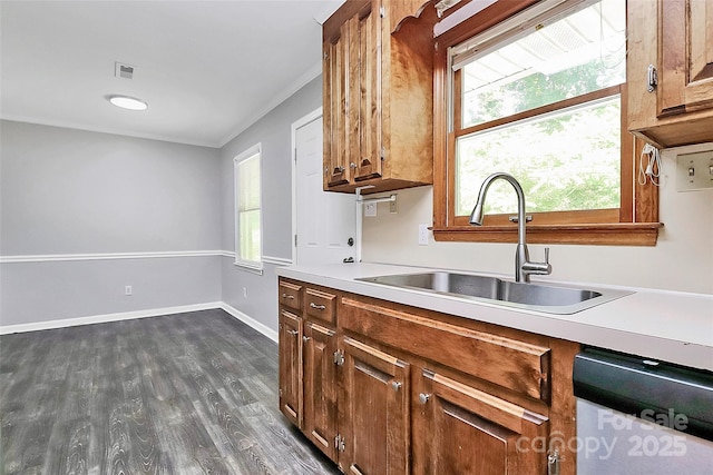 kitchen with dishwasher, visible vents, a sink, dark wood-type flooring, and light countertops