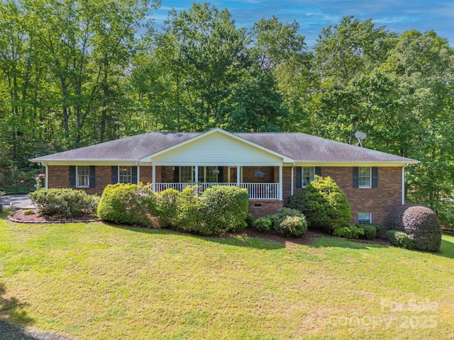 ranch-style home featuring brick siding and a front yard