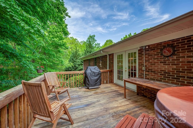 deck featuring french doors and a grill