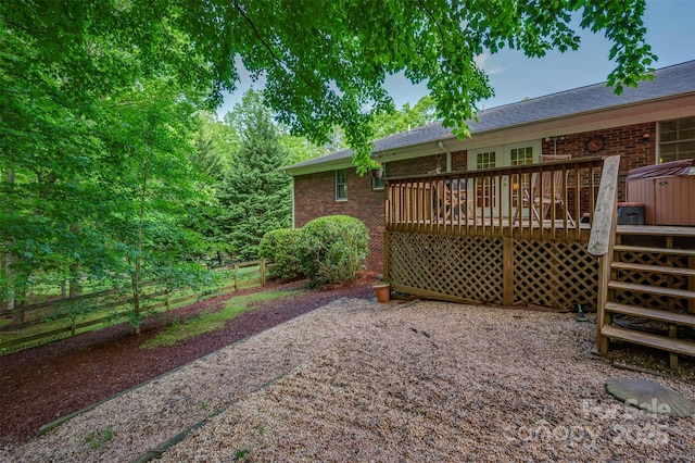 exterior space featuring a wooden deck and fence