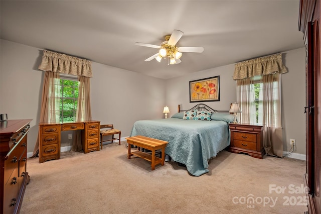 carpeted bedroom with baseboards and ceiling fan