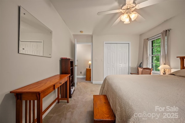 carpeted bedroom featuring baseboards, a ceiling fan, and a closet