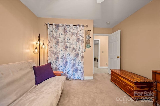carpeted living room featuring baseboards and a ceiling fan