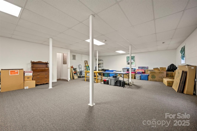 basement featuring carpet and a drop ceiling