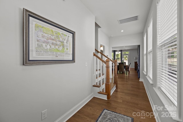 hall featuring visible vents, baseboards, dark wood-style floors, stairway, and recessed lighting