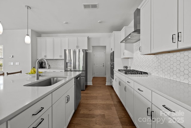 kitchen featuring a sink, appliances with stainless steel finishes, white cabinetry, and light countertops