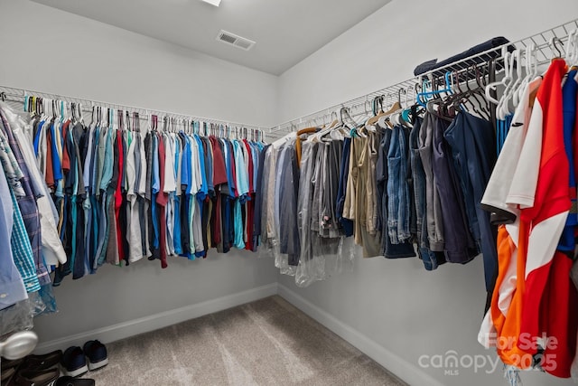 walk in closet featuring carpet flooring and visible vents