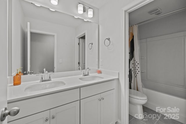 full bathroom featuring a sink, tile patterned floors, toilet, and double vanity