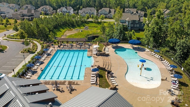 community pool featuring a residential view and a patio area