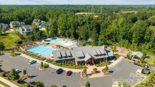 drone / aerial view featuring a wooded view