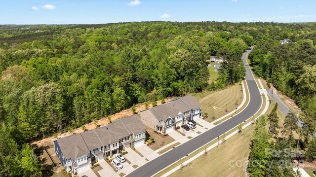 birds eye view of property with a wooded view