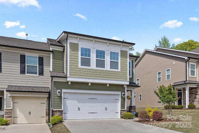 view of front of house with a garage, stone siding, and concrete driveway