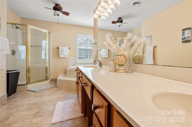 bathroom with ceiling fan, a sink, double vanity, a garden tub, and a stall shower