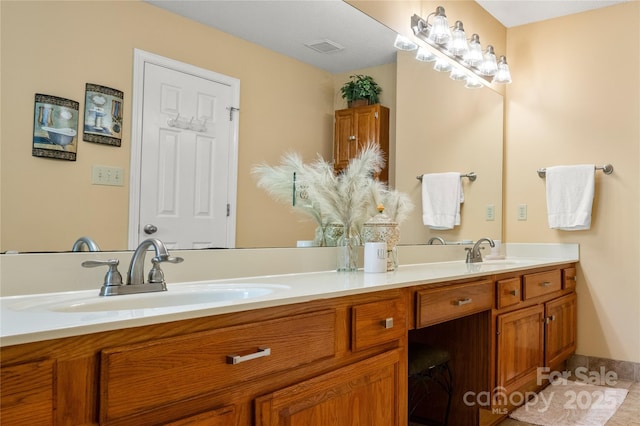 full bath with a sink, double vanity, and visible vents