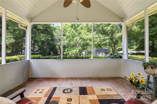 unfurnished sunroom with ceiling fan and plenty of natural light