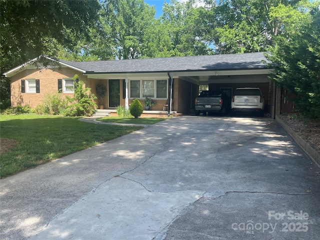 single story home featuring a front lawn, driveway, a carport, and a shingled roof