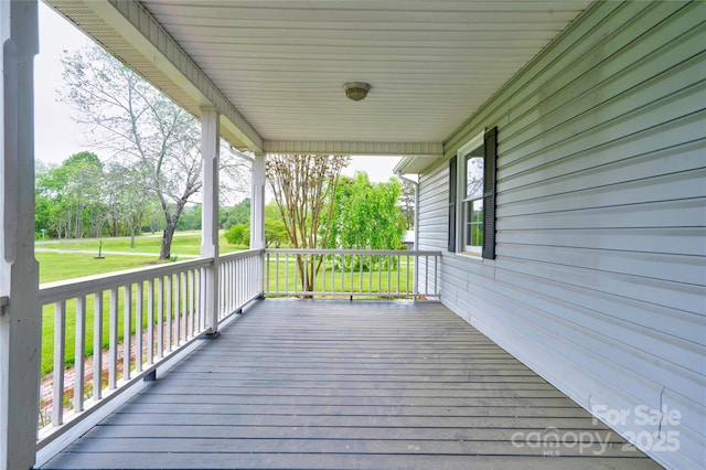deck with a porch and a lawn