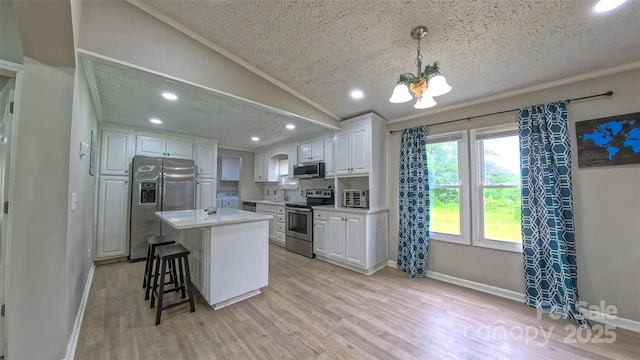 8140 Karriker Rd, Kannapolis, NC 28081 - kitchen featuring appliances with stainless steel finishes, a sink, white cabinetry, light wood-style floors, and a textured ceiling