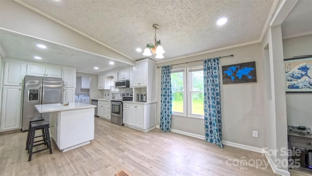 8140 Karriker Rd, Kannapolis, NC 28081 - kitchen featuring stainless steel appliances, a textured ceiling, washer and clothes dryer, a sink, and white cabinets