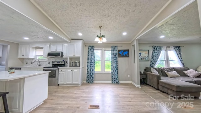 8140 Karriker Rd, Kannapolis, NC 28081 - kitchen featuring appliances with stainless steel finishes, a textured ceiling, a sink, crown molding, and light countertops