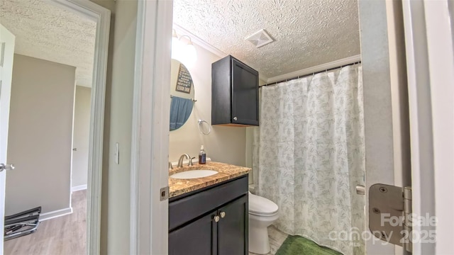 8140 Karriker Rd, Kannapolis, NC 28081 - full bathroom featuring a textured ceiling, toilet, vanity, wood finished floors, and a shower with shower curtain