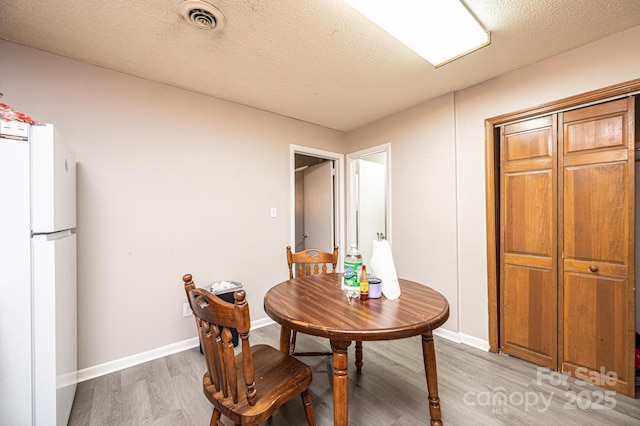 230 Park Ln, Newton, NC 28658 - dining space with light wood-style floors, baseboards, and a textured ceiling