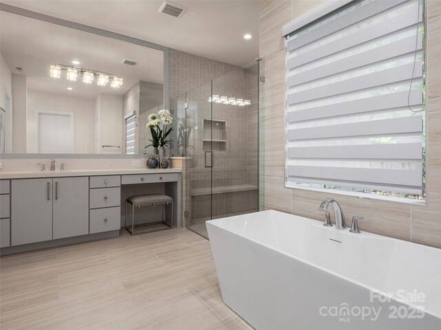 60 Running Creek Trl, Arden, NC 28704 - bathroom featuring a stall shower, vanity, a freestanding tub, recessed lighting, and tile walls