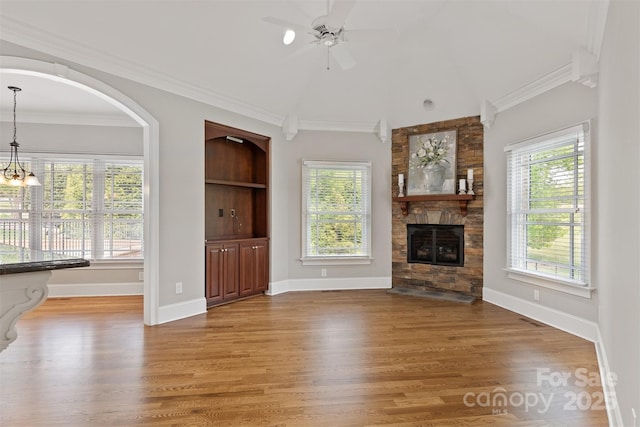 unfurnished living room featuring light wood finished floors, baseboards, a fireplace, and ceiling fan