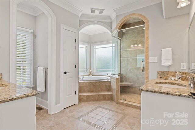 bathroom featuring a wealth of natural light, vanity, a stall shower, and visible vents