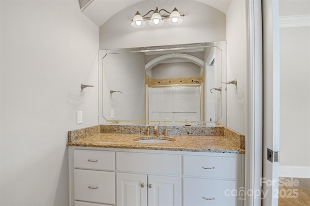 full bathroom featuring baseboards and vanity