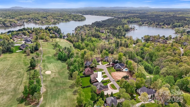 aerial view with a water and mountain view, a view of trees, and a residential view