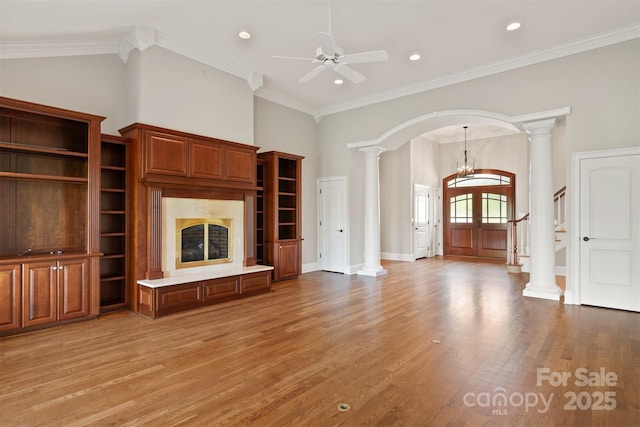 unfurnished living room featuring light wood finished floors, arched walkways, decorative columns, recessed lighting, and ceiling fan