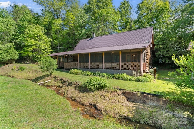 1154 Woodrow Pl, Lenoir, NC 28645 - back of house with log siding, a lawn, metal roof, and a sunroom