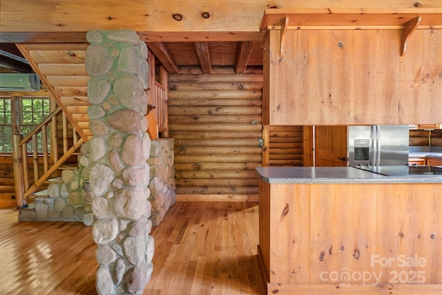 1154 Woodrow Pl, Lenoir, NC 28645 - kitchen with stainless steel fridge with ice dispenser, log walls, wood-type flooring, a wall unit AC, and beam ceiling