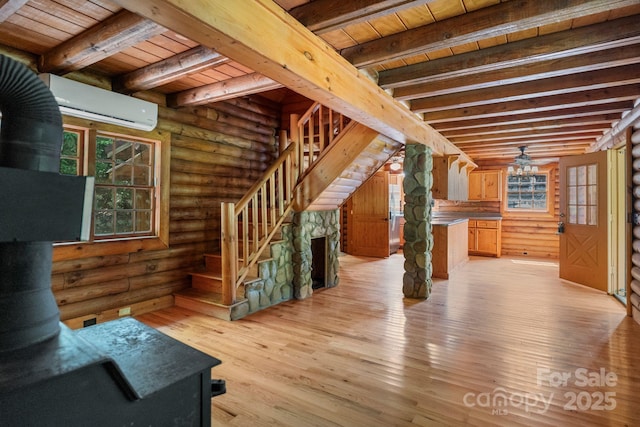 1154 Woodrow Pl, Lenoir, NC 28645 - unfurnished living room with wooden ceiling, an AC wall unit, beamed ceiling, log walls, and plenty of natural light