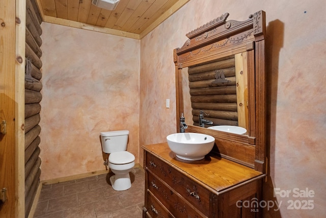 1154 Woodrow Pl, Lenoir, NC 28645 - bathroom featuring log walls, toilet, vanity, wooden ceiling, and tile patterned flooring