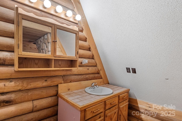 1154 Woodrow Pl, Lenoir, NC 28645 - bathroom featuring rustic walls, vanity, and a textured wall
