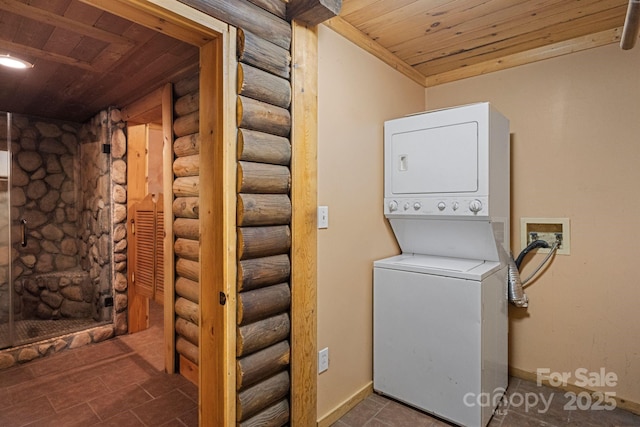 1154 Woodrow Pl, Lenoir, NC 28645 - washroom featuring stacked washing machine and dryer, wood ceiling, log walls, and baseboards