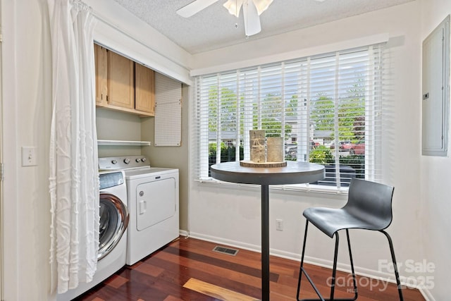 clothes washing area with dark wood-style floors, cabinet space, washing machine and clothes dryer, a ceiling fan, and baseboards