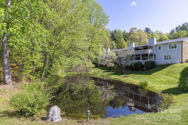 back of property with a lawn and a chimney