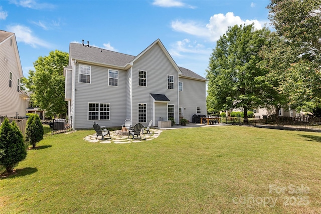 rear view of house with a patio area and an outdoor fire pit