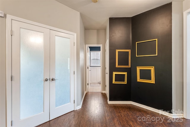 hall with french doors, dark wood-style floors, and baseboards