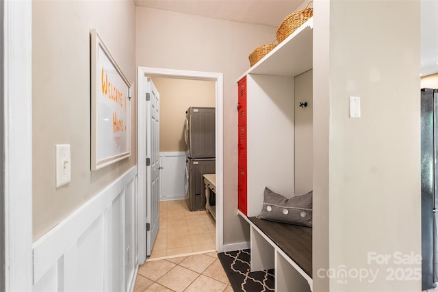 mudroom featuring light tile patterned floors and a wainscoted wall