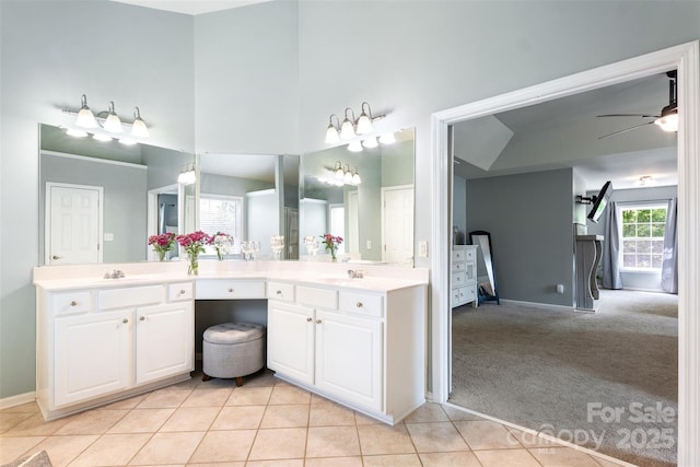 bathroom with ensuite bath, baseboards, vanity, a ceiling fan, and tile patterned flooring