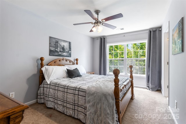 carpeted bedroom featuring baseboards and a ceiling fan