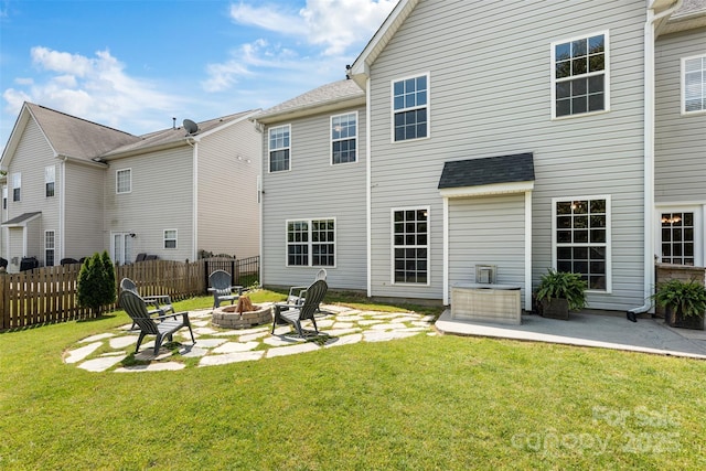 back of property featuring a fire pit and a patio area