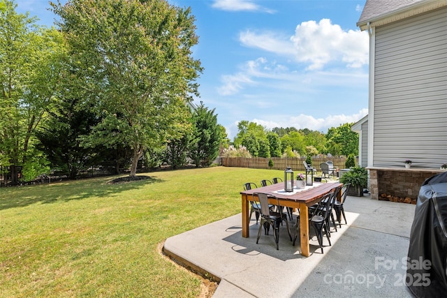 view of yard with outdoor dining space and a patio area