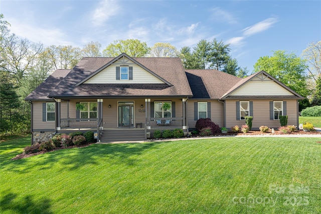 craftsman-style home featuring covered porch, roof with shingles, and a front lawn