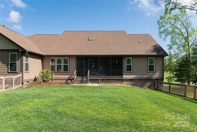 rear view of house featuring crawl space, a lawn, a sunroom, fence, and a shingled roof