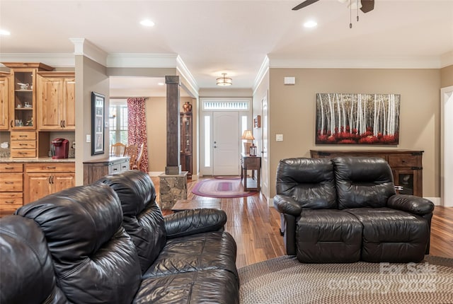 living room with ornate columns, ceiling fan, ornamental molding, and wood finished floors